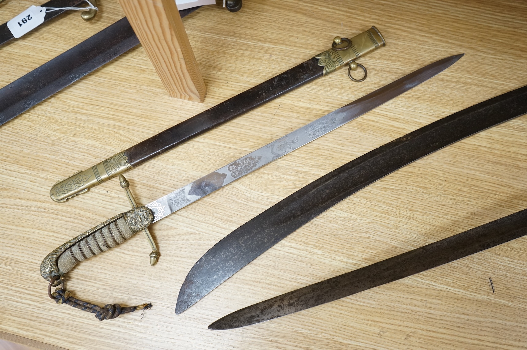 A post 1902 Naval Officer’s Dirk, the regulation blade with crowned fouled anchor, regulation hilt with remains of bullion dress knot in its leather scabbard with brass mounts, locket engraved with owners initials; RSA